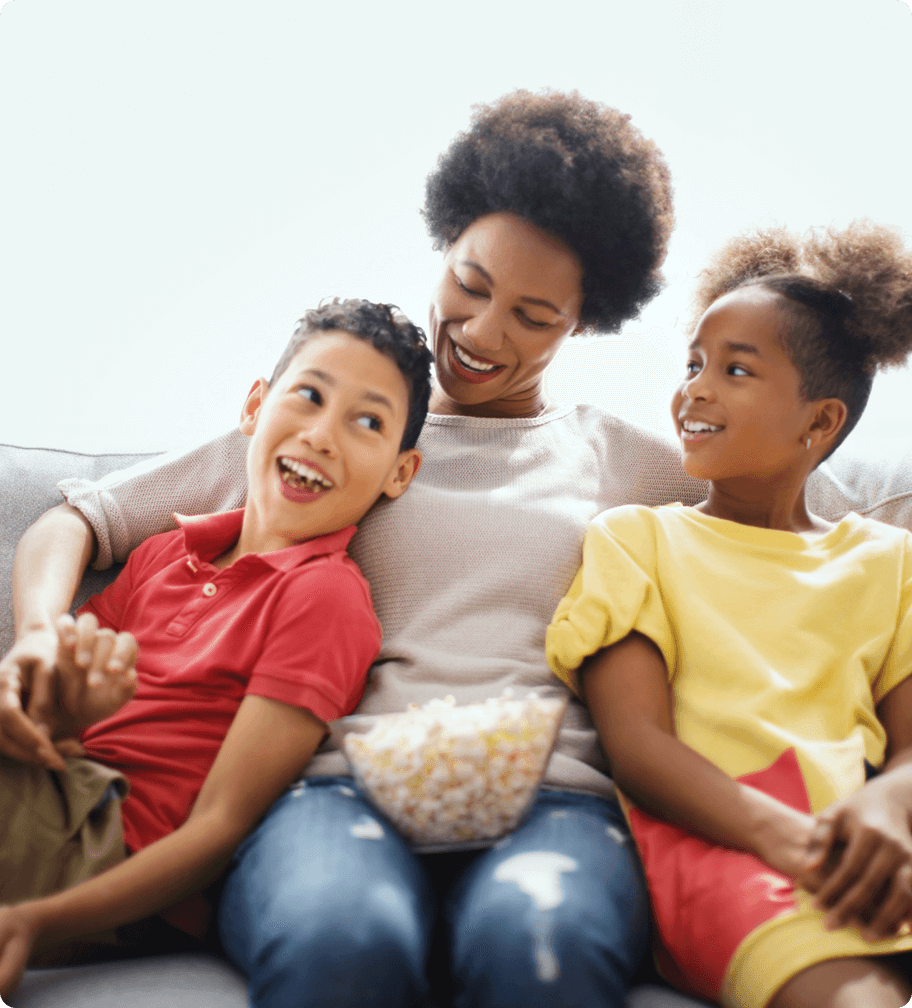 A mother and her two kids eating popcorn