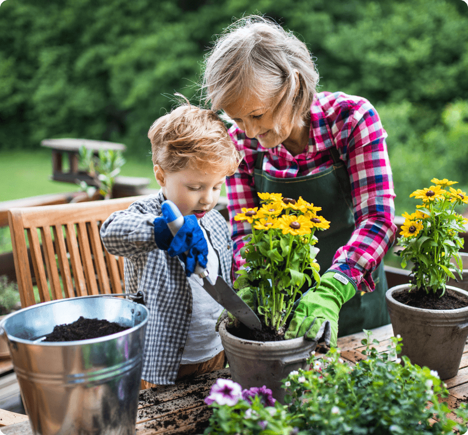 A grandmother and grandson gardening.